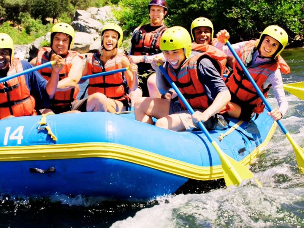 A group of people enjoying Whitewater rafting on the French Broad